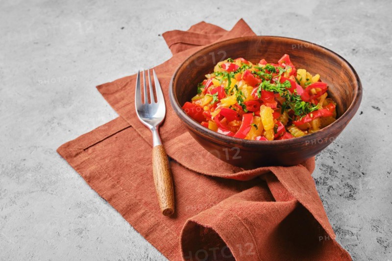 Clay bowl with vegetable ragout on a napkin
