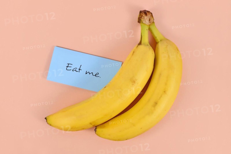 Two banana fruits with note saying eat me