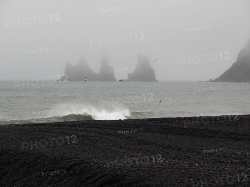 Rainy atmosphere, cliff in the fog, rock Reynisdrangar in the water, at Reynisfjara beach, black lava beach, Vik, South Iceland, Iceland, Europe