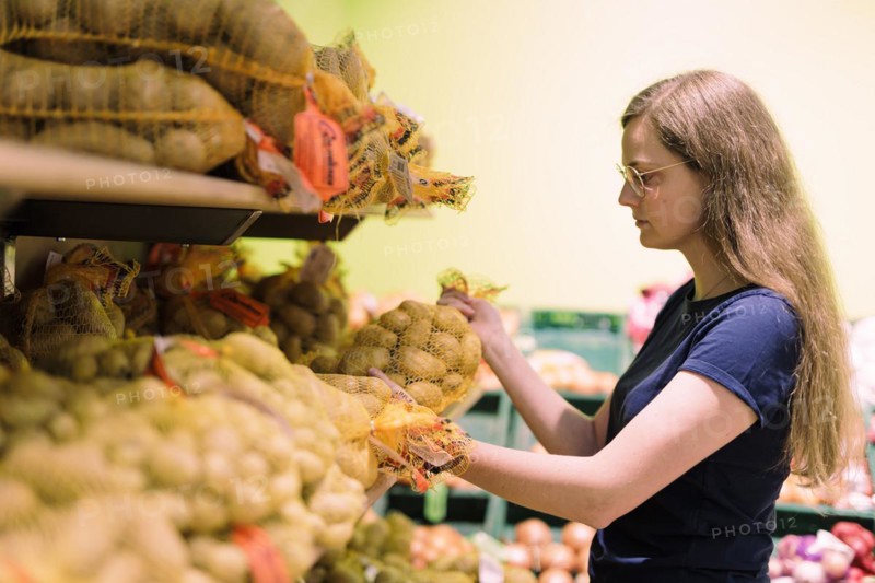 Younger woman shopping in supermarket, Radevormwald, Germany, Europe