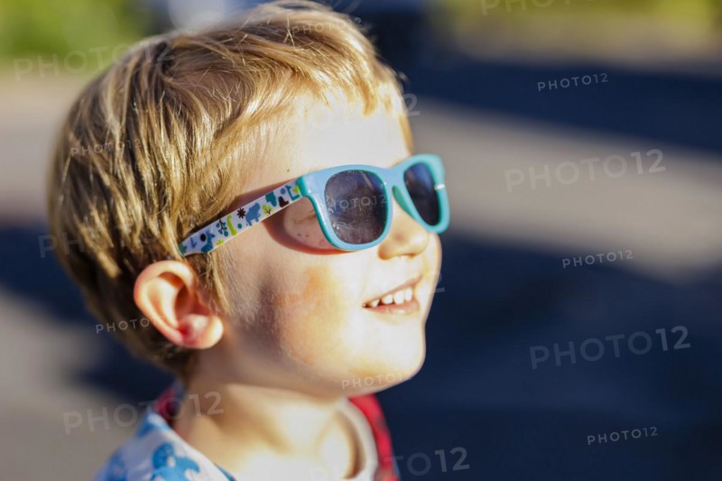 Toddler with sunglasses, enjoying autumn sunshine. Bonn, Germany, Europe