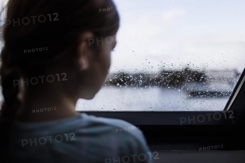 Girl looking out of the window, Bonn, Germany, Europe