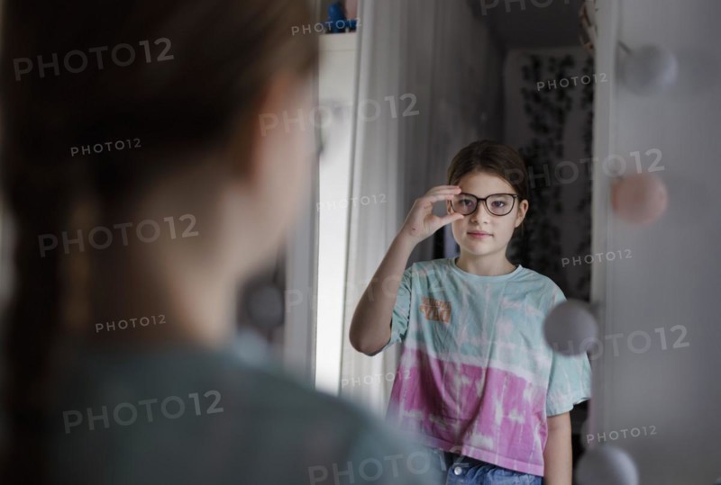 Ten year old girl betrays herself in the mirror, Bonn, Germany, Europe