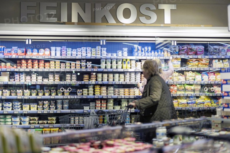 Elderly woman shopping in the delicatessen department at the supermarket, Radevormwald, Germany, Europe