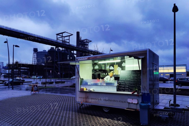 Outside snack bar in front of the Phoenix West blast furnace at dusk, Dortmund, Ruhr area, North Rhine-Westphalia, Germany, Europe