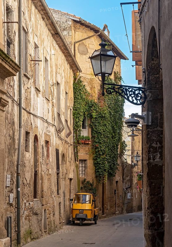 Three-wheeler in the streets of Pitigliano old town, Tuscany, Italy, Europe