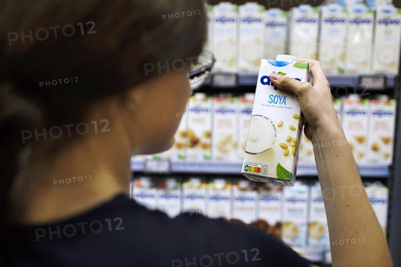 Young woman shopping in supermarket. Radevormwald, Germany, Europe