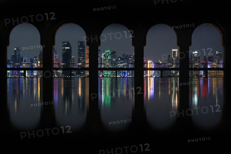 View of the illuminated skyline of Doha, Qatar, from the terrace of the Museum of Islamic Art by the archtics Ieoh Ming Pei and Jean-Michel Wilmotte, Asia