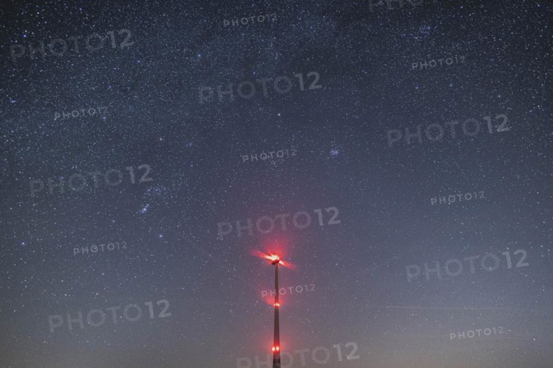 An illuminated wind turbine stands out against the starry sky in Vierkirchen, 14.02.2023., Vierkirchen, Germany, Europe