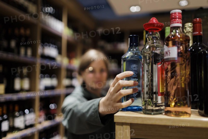 Young woman, buying alcoholic beverages at the supermarket. Radevormwald, Germany, Europe