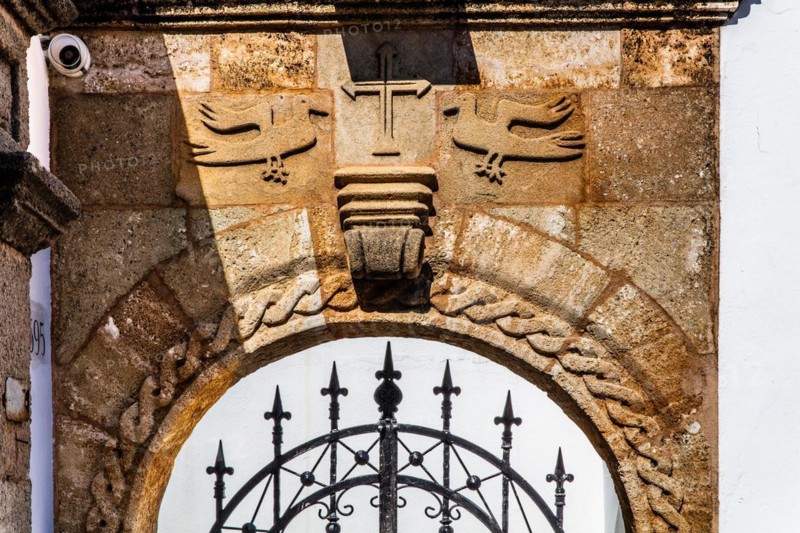Old wooden doors with pebble mosaics on the floor, winding streets with white houses, Lindos, Rhodes, Greece, Europe