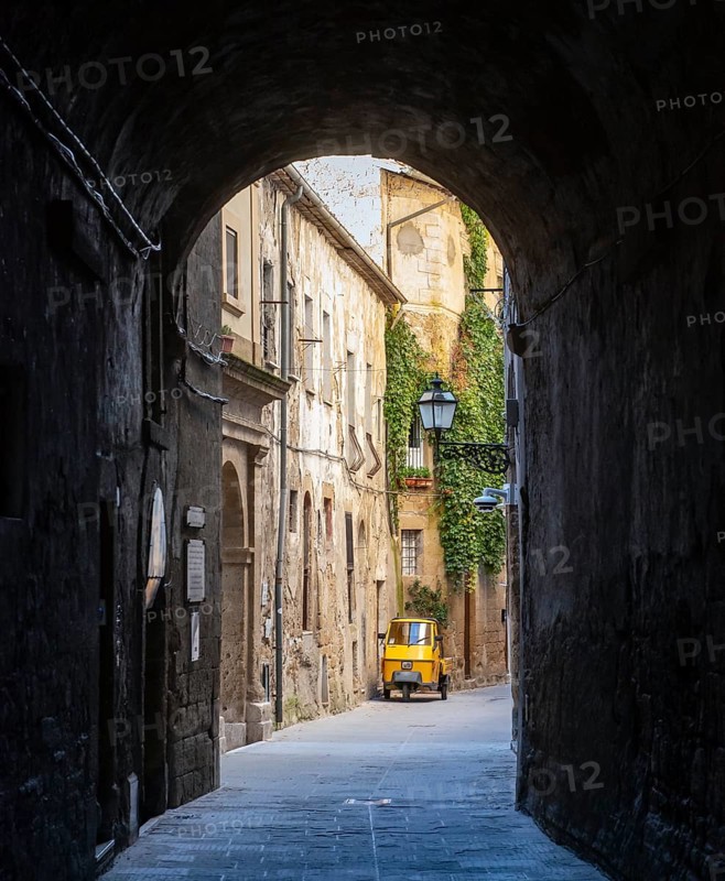 Three-wheeler in the streets of Pitigliano old town, Tuscany, Italy, Europe
