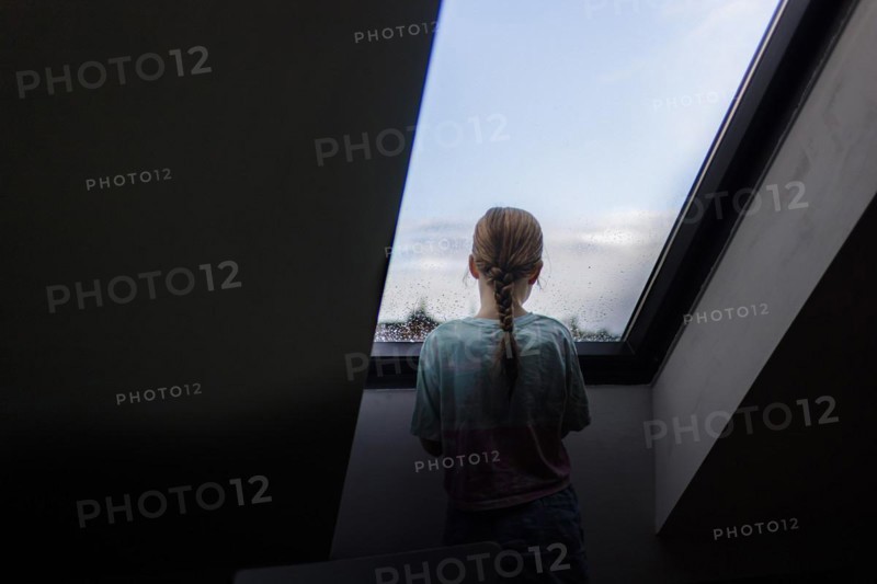 Girl looking out of the window, Bonn, Germany, Europe