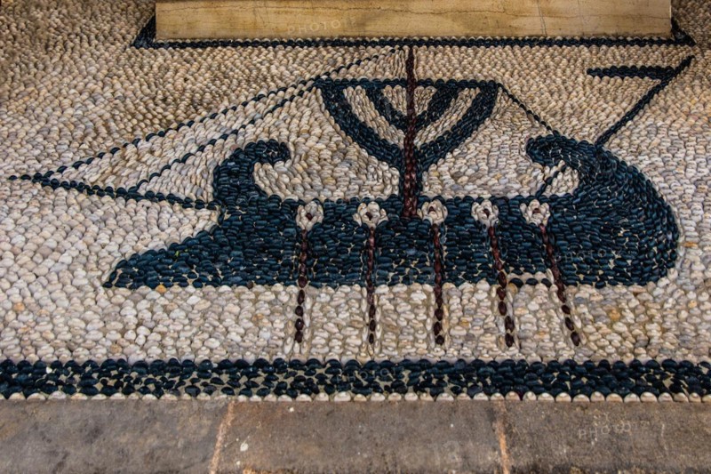 Old wooden doors with pebble mosaics on the floor, winding streets with white houses, Lindos, Rhodes, Greece, Europe