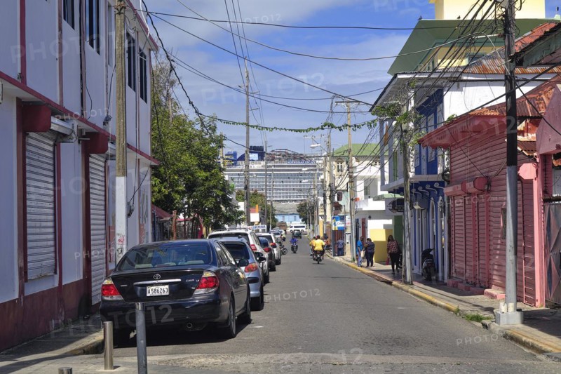 Street with colonial houses and cruise ship in Centro Historico, Old Town of Puerto Plata, Dominican Republic, Caribbean, Central America