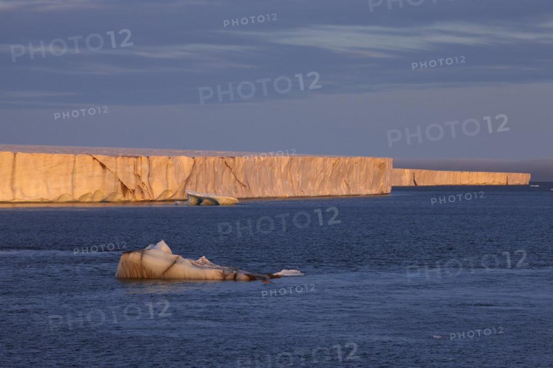 Brasvellbreen coastal glacier, glacier front in the evening light at sunset, ice chunks floating in front of it, Nordaustlandet, Svalbard