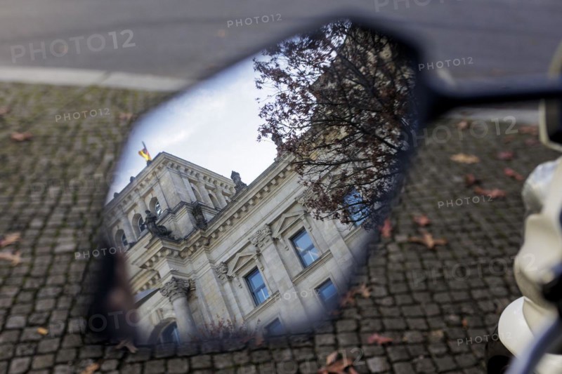 Part of the building of the German Bundestag can be seen in a motorbike mirror. Berlin, Berlin, Germany, Europe