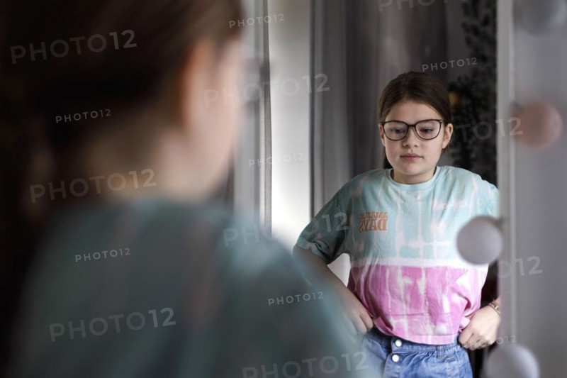 Ten year old girl betrays herself in the mirror, Bonn, Germany, Europe