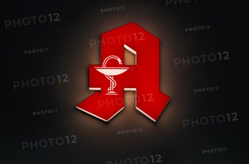 Red neon sign, sign pharmacy with Aesculap staff, Aesculapian staff, night shot, Stuttgart, Baden-Wuerttemberg, Germany, Europe