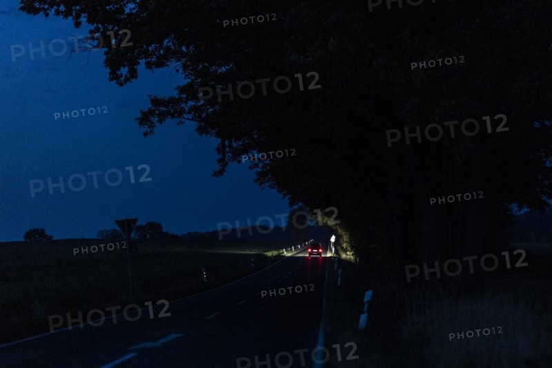 A car driving along a country road at blue hour in Reichenbach, Reichenbach, Germany, Europe
