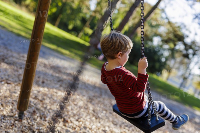 Child on a swing. Bonn, Germany, Europe