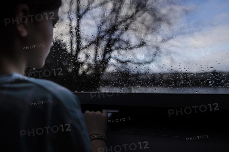 Girl looking out of the window, Bonn, Germany, Europe