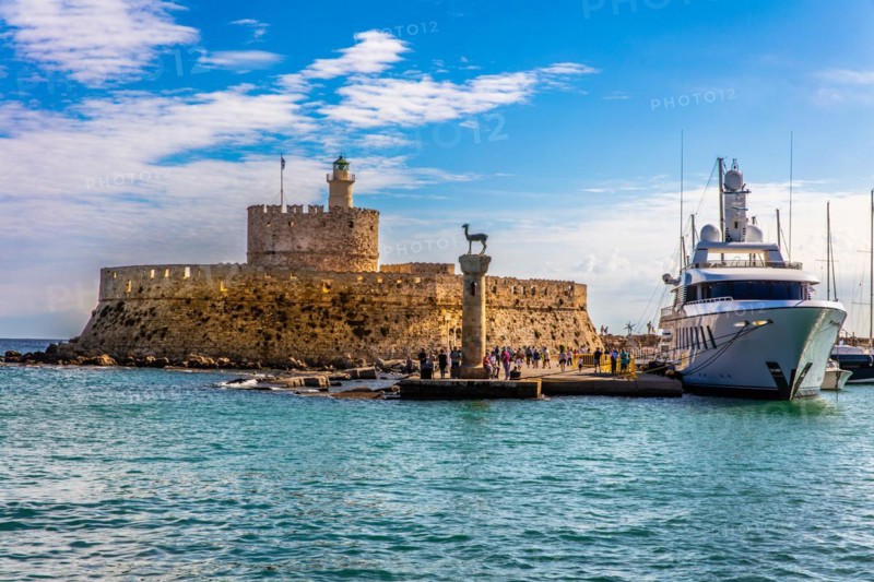 Mandraki harbour, harbour entrance with columns with stag and hind, site of the Colossus of Rhodes, Rhodes Town, Greece, Europe