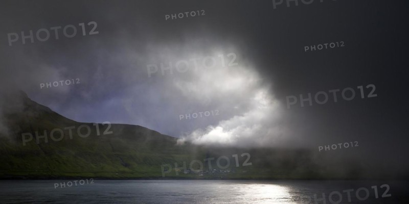 The island of Kalsoy with the small village of Mikladalur in the North Atlantic with very dramatic lighting, Faroe Islands, Foroyar, Denmark, Europe