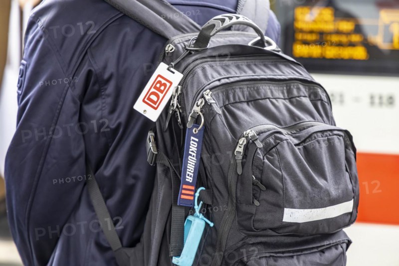 Locomotive driver with backpack and distinctive sign of the locomotive drivers of the Deutsche Bahn, main station, Stuttgart, Baden-Wuerttemberg, Germany, Europe