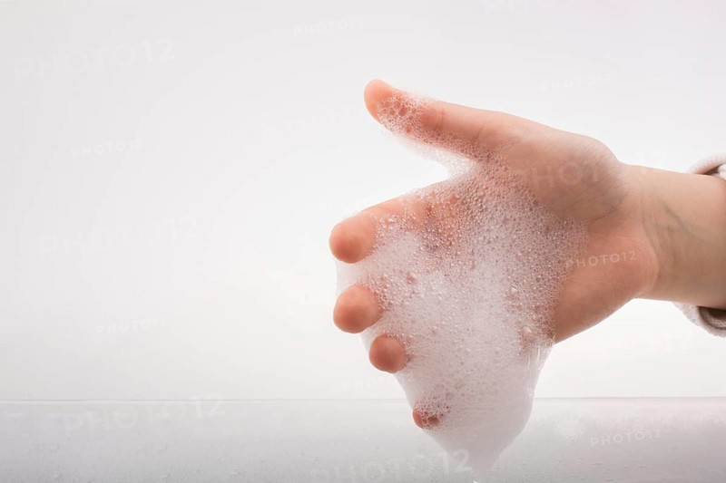 Hand washing and soap foam on a foamy background