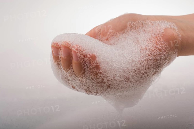 Hand washing and soap foam on a foamy background