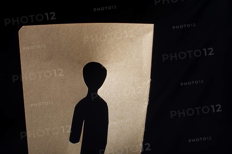 Man shape cut out of paper in hand in the view