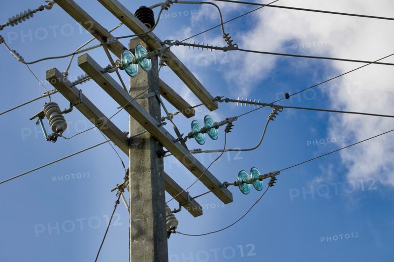 Concrete electricity poles with porcelain and glass insulators