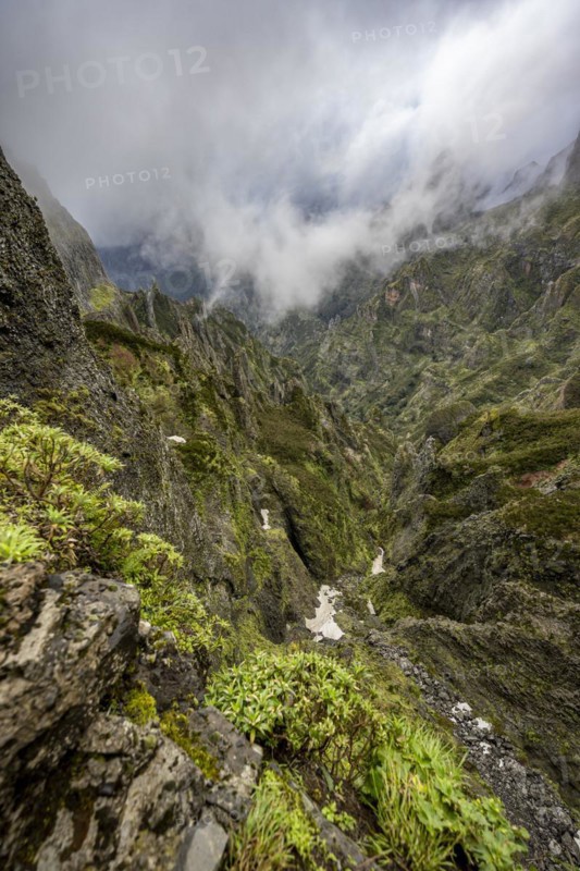 Steep cloudy mountain landscape with rock formations