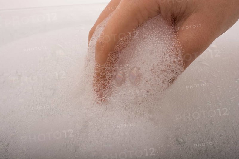 Hand washing and soap foam on a foamy background