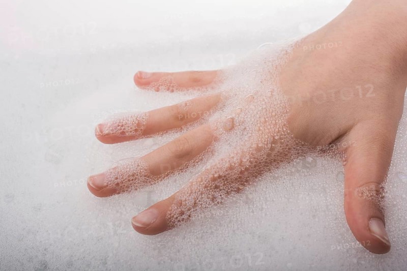 Hand washing and soap foam on a foamy background