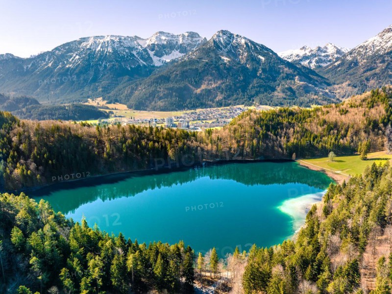 Lake in the forest with mountain panorama