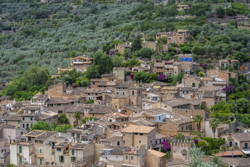 View of typical houses of the mountain village Fornalutx with church Parroquia catolica La Natividad de la virgen Maria
