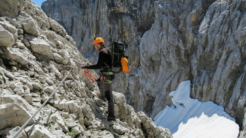 Tourist with equipment on the via ferrata trail in the alps. Zugspitze massif