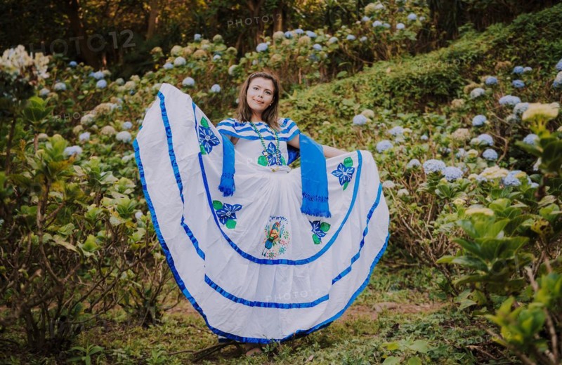 Girl in Nicaraguan national folk costume. Young Nicaraguan woman in traditional folk costume in a field of Milflores