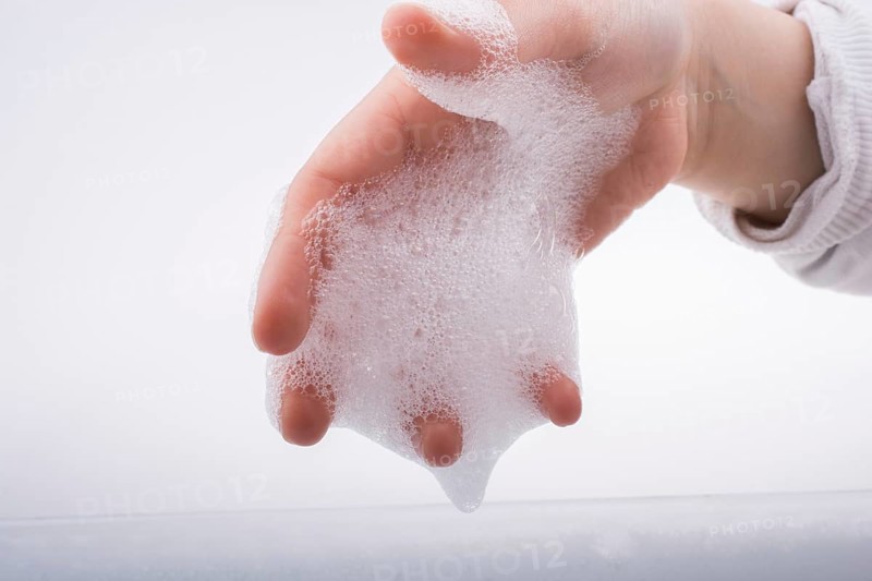 Hand washing and soap foam on a foamy background