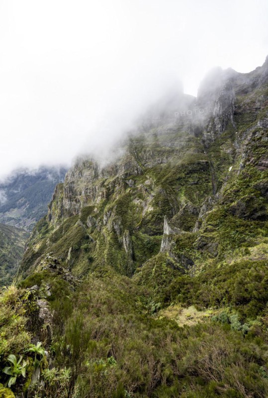 Steep cloudy mountain landscape with rock formations