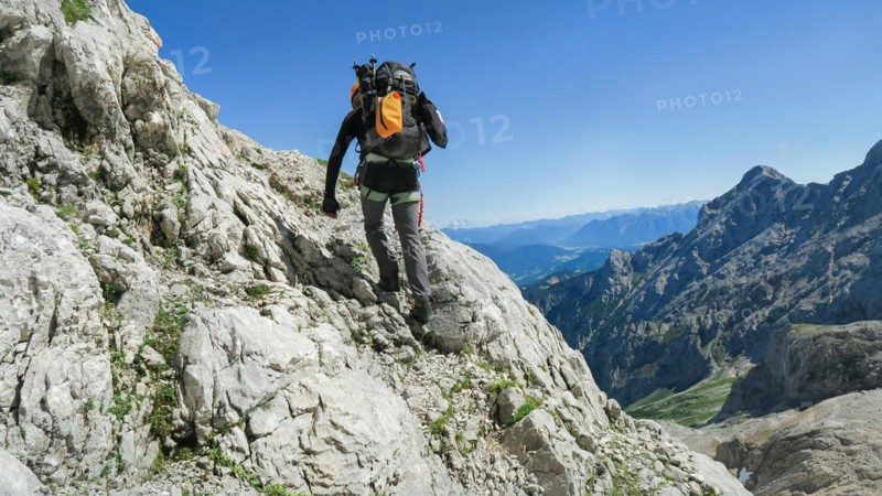 Tourist with equipment on the via ferrata trail in the alps. Zugspitze massif