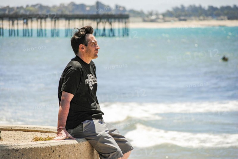 A man looking the ocean near Ventura Pier