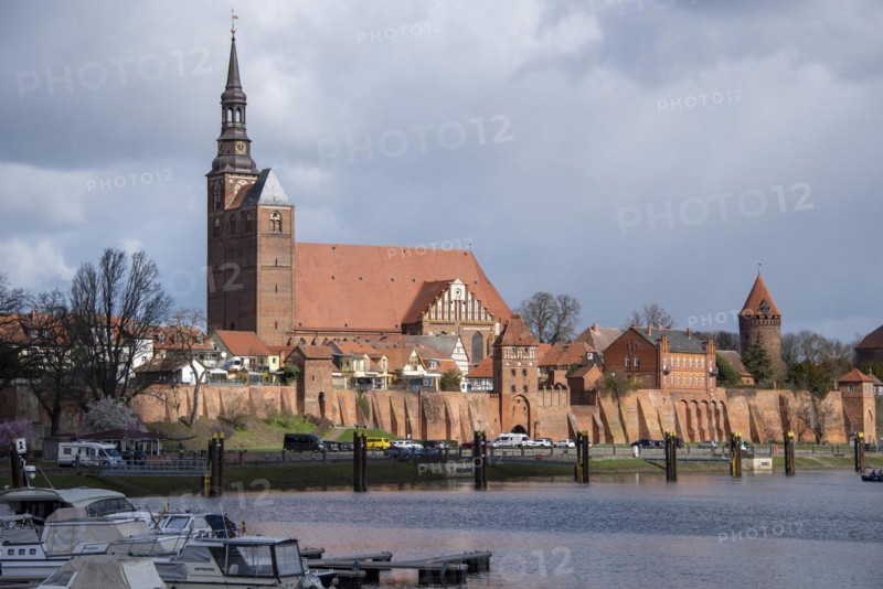 Historic town wall with defence defence tower and St. Stephens Church