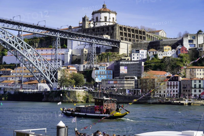 View of the Dom Luis I bridge over Douro River and terracota rooftops