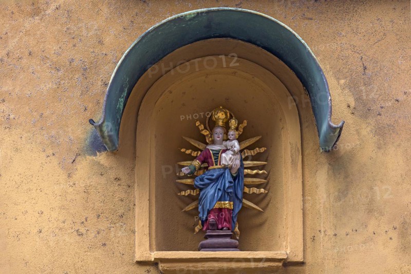 Sculpture of Mary with the Child Jesus in a niche on a residential house