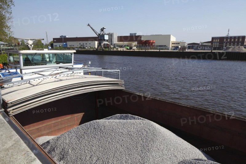 Barge in port loaded with bulk cargo