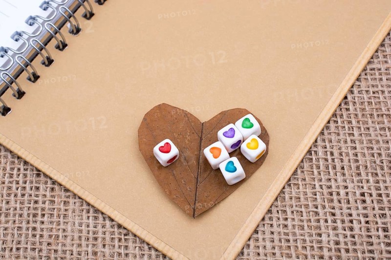 Colorful cubes with a heart on notebook on canvas
