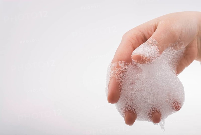 Hand washing and soap foam on a foamy background